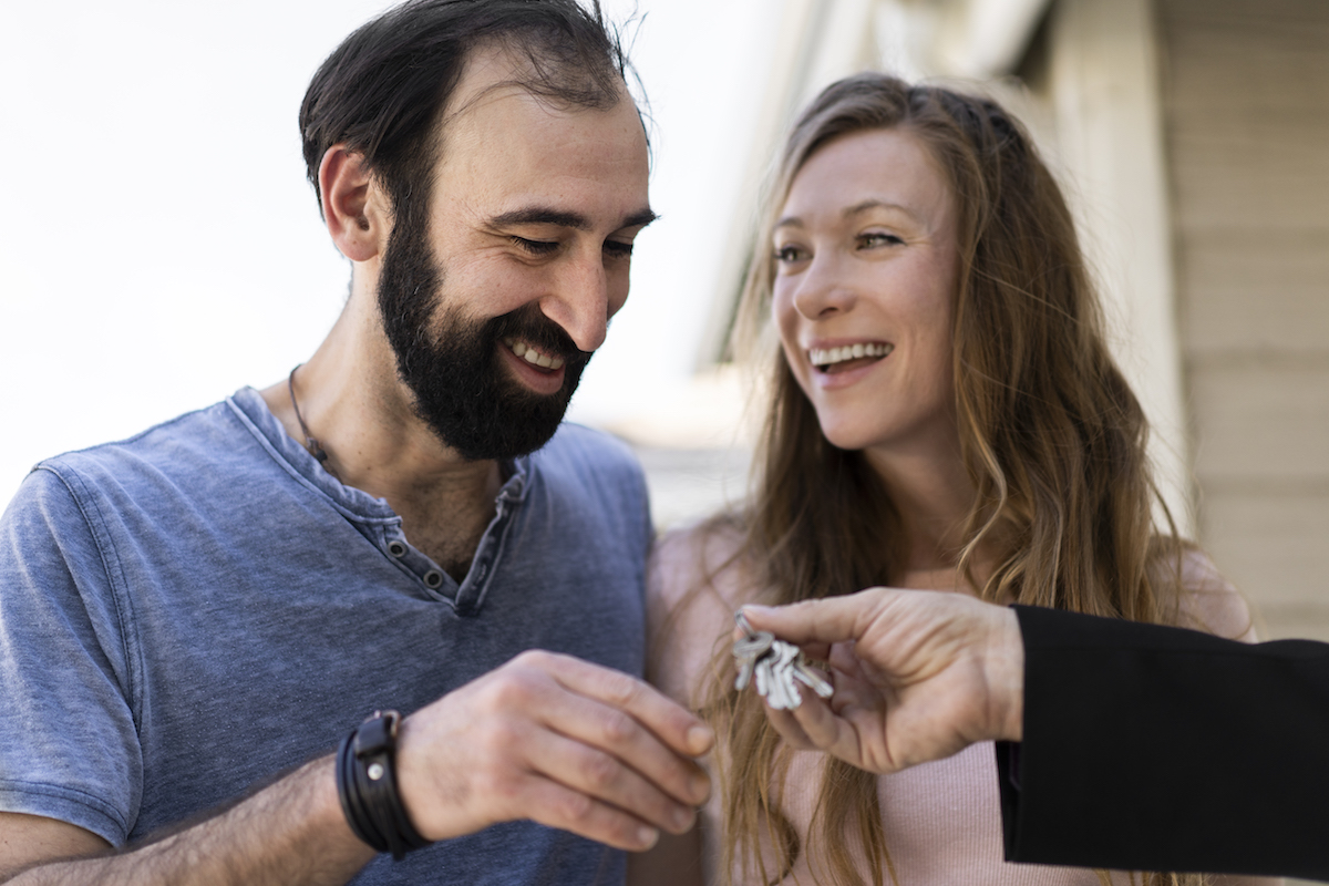 Couple getting keys to new house