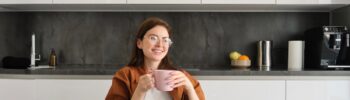 Young woman sitting in a kitchen