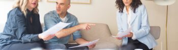 Middle aged couple meeting with lawyer.