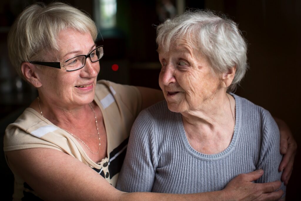 An elderly woman with her adult daughter.